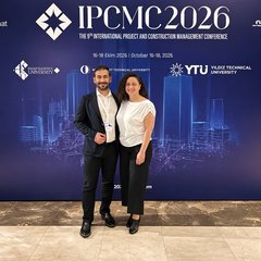 Kutbeddin Ağca and Selen Baş Ağca in front of the IPCMC 2026 backdrop, showing the conference name, dates and the logos of the organising universities